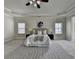 Spacious main bedroom with carpet floors and tray ceilings allows for ample natural light from the well-placed windows at 4610 Point Rock Dr, Buford, GA 30519