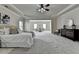 Spacious main bedroom with tray ceilings, sitting area, carpet floors, and windows allowing for ample natural light at 4610 Point Rock Dr, Buford, GA 30519
