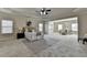 Large main bedroom with sitting area boasts tray ceilings, carpet floors, and ample natural light from many windows at 4610 Point Rock Dr, Buford, GA 30519