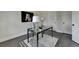 Office with gray wood flooring, neutral walls, a modern glass desk, and white trim at 4610 Point Rock Dr, Buford, GA 30519