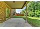 Covered patio with brick accents overlooks the fenced yard at 4610 Point Rock Dr, Buford, GA 30519