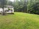 Lush green backyard surrounded by mature trees, offering privacy and a serene atmosphere at 3014 Echols Rd, Cumming, GA 30041