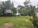 Spacious backyard featuring a large treehouse with a slide and climbing stairs at 3014 Echols Rd, Cumming, GA 30041
