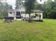 Expansive backyard with a patio for outdoor living and mature trees providing shade at 3014 Echols Rd, Cumming, GA 30041