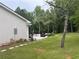 Relaxing backyard featuring a patio area with outdoor seating and a well-maintained lawn at 3014 Echols Rd, Cumming, GA 30041