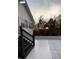 Backyard featuring a spacious patio area and a staircase with a wooded backdrop at sunset at 3014 Echols Rd, Cumming, GA 30041