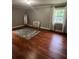 Spacious bedroom featuring hardwood floors, a bright window and a cozy, floral rug at 3014 Echols Rd, Cumming, GA 30041