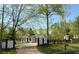 Charming home featuring a well-manicured lawn, white exterior, and a fenced yard at 3014 Echols Rd, Cumming, GA 30041