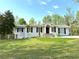 Well-maintained single-story home with a lush green lawn and manicured landscaping at 3014 Echols Rd, Cumming, GA 30041