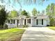 Lovely single-story home with a manicured lawn, arched entryway, and well-kept garden at 3014 Echols Rd, Cumming, GA 30041