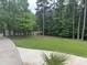 Well-maintained front yard featuring a healthy lawn and a paved driveway at 3014 Echols Rd, Cumming, GA 30041