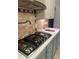Modern kitchen with stainless steel stovetop, updated backsplash, and countertops at 3014 Echols Rd, Cumming, GA 30041