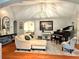 Bright living room featuring hardwood floors, neutral furniture, and a grand piano at 3014 Echols Rd, Cumming, GA 30041