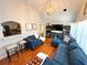 Spacious living room features hardwood floors, blue sofa, and open layout to kitchen at 3014 Echols Rd, Cumming, GA 30041