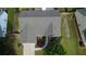 Aerial view showcasing a well-maintained roof and landscaped front yard with driveway access at 5298 Autumn Run Dr, Powder Springs, GA 30127