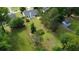 Aerial view highlighting a spacious backyard, mature trees, and a storage shed at 5298 Autumn Run Dr, Powder Springs, GA 30127
