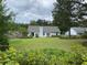 Large backyard with lush green lawn, mature trees, and privacy fence at 5298 Autumn Run Dr, Powder Springs, GA 30127