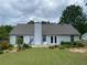 The backyard features a well-maintained lawn and patio with chairs, perfect for outdoor relaxation at 5298 Autumn Run Dr, Powder Springs, GA 30127