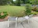 Backyard features a lush lawn, landscape and patio seating perfect for outdoor relaxation at 5298 Autumn Run Dr, Powder Springs, GA 30127