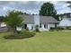 A backyard boasting a well-kept lawn, a patio with furniture, and privacy-enhancing landscaping for a serene outdoor space at 5298 Autumn Run Dr, Powder Springs, GA 30127