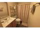 Bathroom with a single sink vanity, dark flooring, and a shower with decorative curtain at 5298 Autumn Run Dr, Powder Springs, GA 30127