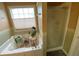 Bathroom garden tub with plants and tile flooring at 5298 Autumn Run Dr, Powder Springs, GA 30127