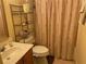 Bathroom with a shower with patterned curtain, vanity and shelving for storage at 5298 Autumn Run Dr, Powder Springs, GA 30127