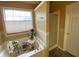 Bathroom featuring a garden tub, shower, large window, and neutral wall colors at 5298 Autumn Run Dr, Powder Springs, GA 30127