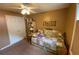 Bedroom featuring a cozy daybed, built-in bookcase and neutral walls with unique art at 5298 Autumn Run Dr, Powder Springs, GA 30127