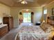 Relaxing bedroom featuring tray ceilings, a ceiling fan, and access to the back yard at 5298 Autumn Run Dr, Powder Springs, GA 30127