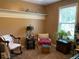 Cozy bedroom with neutral paint, chair, and shelves for decorative storage at 5298 Autumn Run Dr, Powder Springs, GA 30127