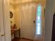 Inviting front foyer featuring a paneled door, side window, and natural light at 5298 Autumn Run Dr, Powder Springs, GA 30127