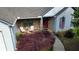 Charming front porch with stone accents, a red front door, and cozy seating arrangement at 5298 Autumn Run Dr, Powder Springs, GA 30127