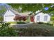 Charming single-story home with well-maintained landscaping and a red front door at 5298 Autumn Run Dr, Powder Springs, GA 30127