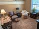 Cozy living room featuring vintage furniture, soft carpet, and natural light from a window at 5298 Autumn Run Dr, Powder Springs, GA 30127