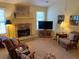 Comfortable living room featuring a stone fireplace, natural light, and stylish furnishings at 5298 Autumn Run Dr, Powder Springs, GA 30127