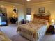 Comfortable main bedroom featuring a floral bedspread, a separate sitting area, and ample space for relaxation at 5298 Autumn Run Dr, Powder Springs, GA 30127