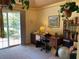 Well-lit home office with built-in shelving, lots of natural light, and direct access to the backyard at 5298 Autumn Run Dr, Powder Springs, GA 30127