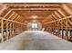 Unfinished attic with exposed beams and framing offers lots of space for storage or conversion at 5335 Bannergate Dr, Johns Creek, GA 30022