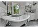 Luxurious bathroom with a freestanding tub, marble accents, and a serene window view at 5335 Bannergate Dr, Johns Creek, GA 30022