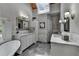 A well-lit bathroom featuring dual sinks, a soaking tub, and a skylight for natural light at 5335 Bannergate Dr, Johns Creek, GA 30022