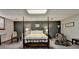 Bedroom featuring a four-poster bed and gray accent wall at 5335 Bannergate Dr, Johns Creek, GA 30022