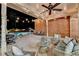 A covered patio with string lights, outdoor seating, and a view of the pool at night at 5335 Bannergate Dr, Johns Creek, GA 30022