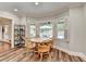 Dining area with floor to ceiling windows overlooking a patio and swimming pool at 5335 Bannergate Dr, Johns Creek, GA 30022