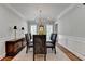 Dining room featuring large windows with wood shutters, chandelier, and a decorative carpet at 5335 Bannergate Dr, Johns Creek, GA 30022