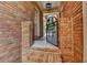 Inviting brick entryway leading to a private backyard with an iron gate at 5335 Bannergate Dr, Johns Creek, GA 30022