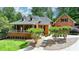 Charming brick home featuring a welcoming front porch and well-manicured landscaping at 5335 Bannergate Dr, Johns Creek, GA 30022