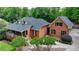 Beautiful brick home with mature landscaping, front porch, and a well-manicured lawn at 5335 Bannergate Dr, Johns Creek, GA 30022