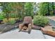 Outdoor brick fireplace with tile patio, offering a cozy spot for gatherings in a private backyard at 5335 Bannergate Dr, Johns Creek, GA 30022