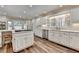 Spacious kitchen with white cabinets, stone countertops, and stainless appliances at 5335 Bannergate Dr, Johns Creek, GA 30022